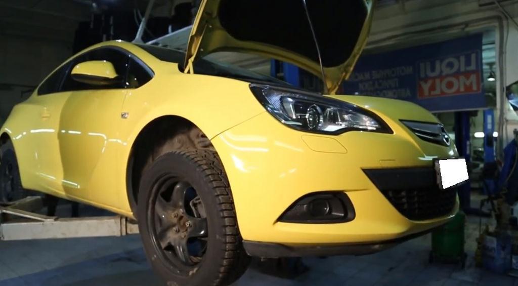 желтая Астра на подъемнике на СТО